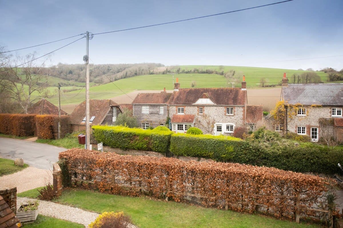 The cottage looks out to other pretty cottages in the village and on to rolling countryside.