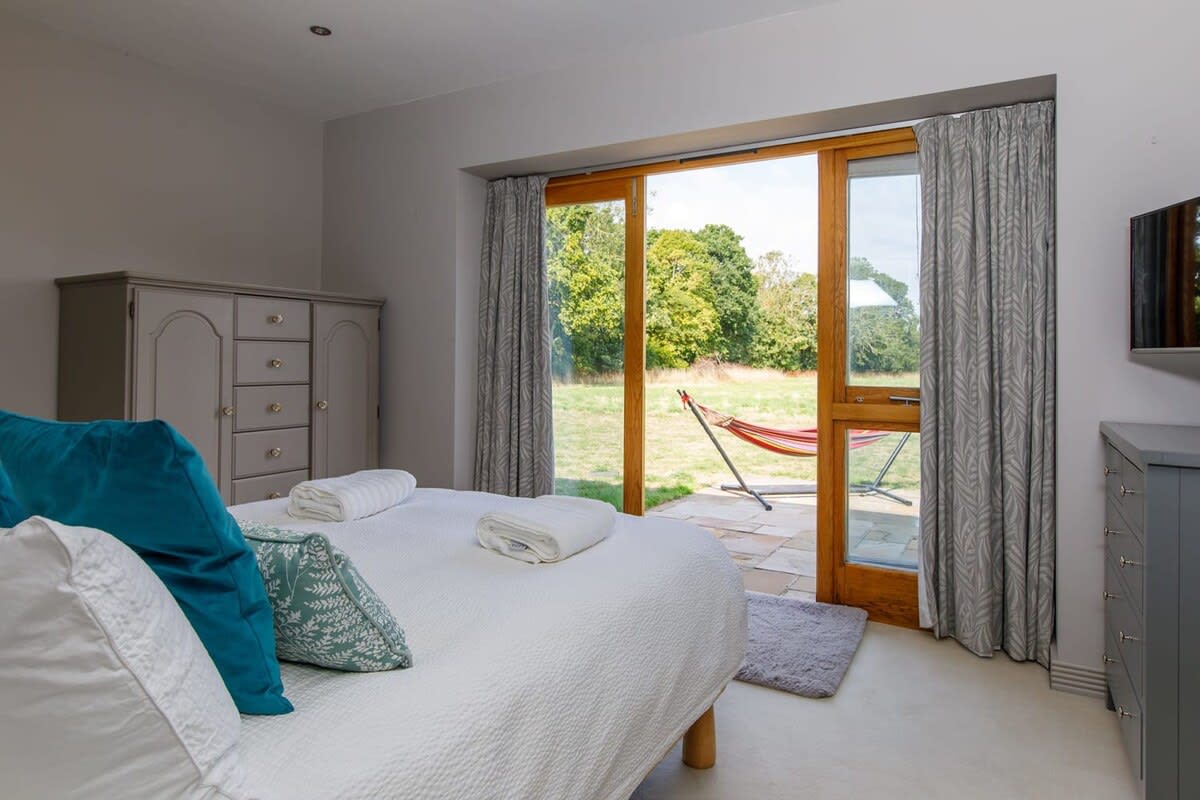 The downstairs king room has patio doors that open up to the secluded garden.