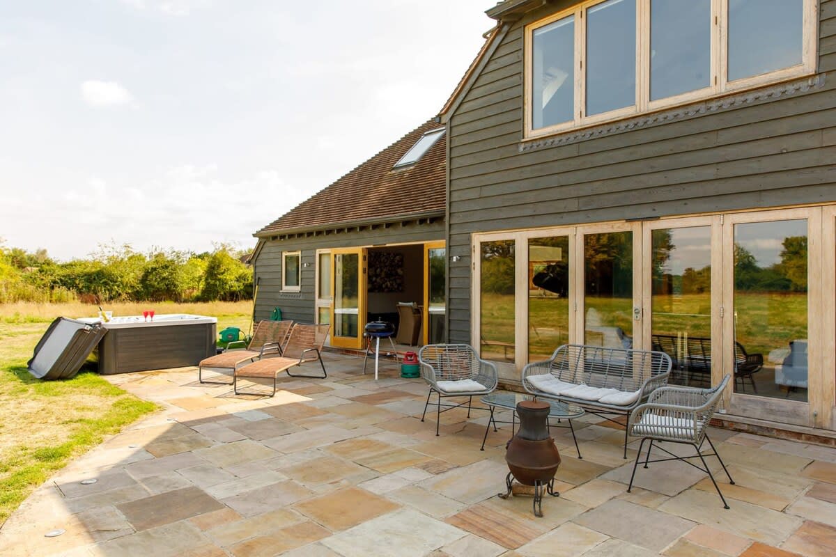 The outdoor area is rural and private, with a large sunny patio, fire pit, sun loungers and hot tub. What more do you need?!