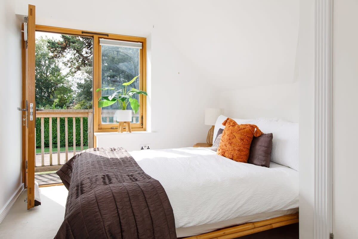 Adjacent double rooms share the beautiful front balcony of the home.