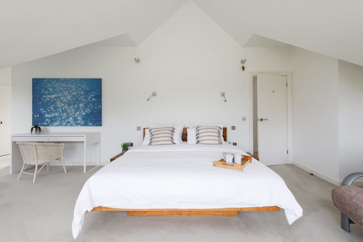 The master bedroom has a walk-in shower and steps up to a luxury bath.