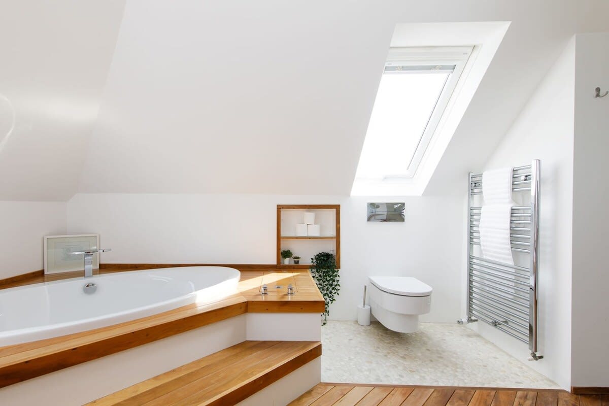 The spacious ensuite has a sunken bath and walk in shower.