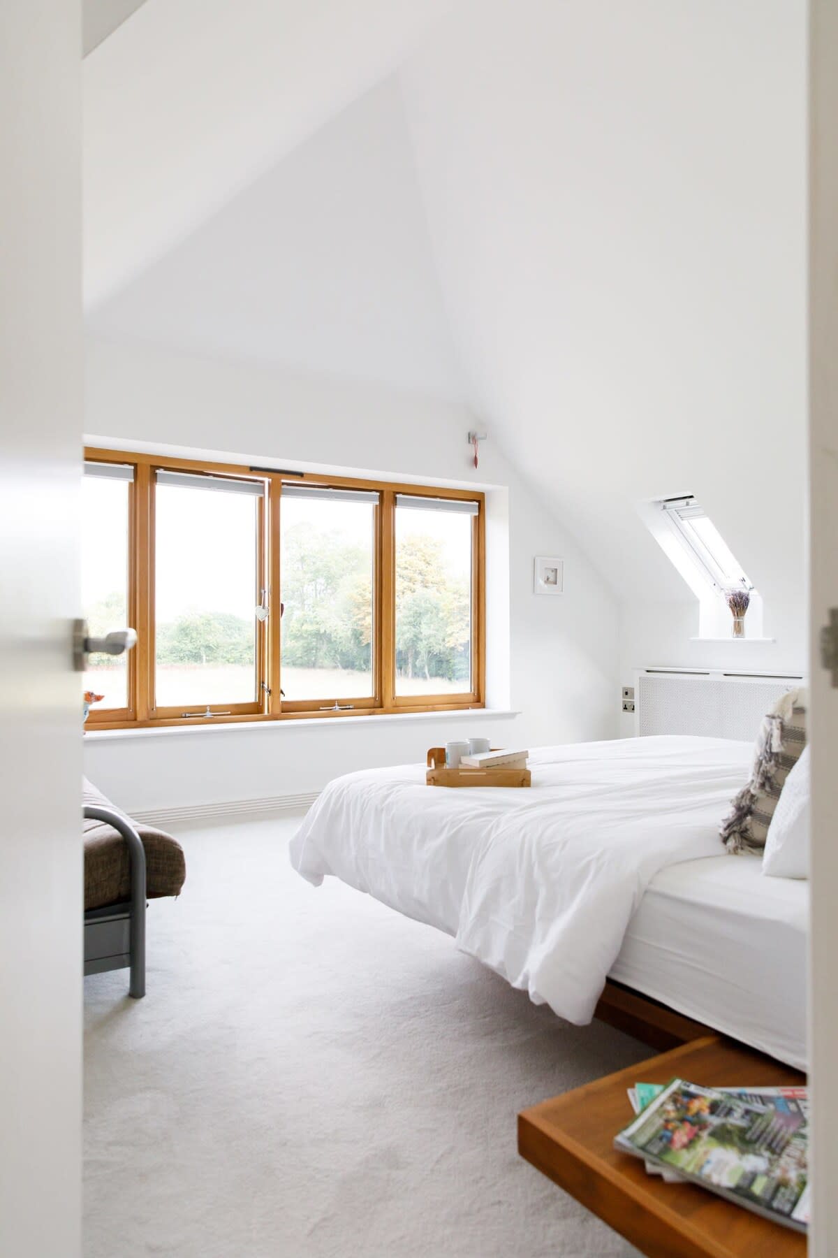 The impressive master bedroom has wonderful views of the lush green surroundings, a luxurious super king bed and grand ensuite.