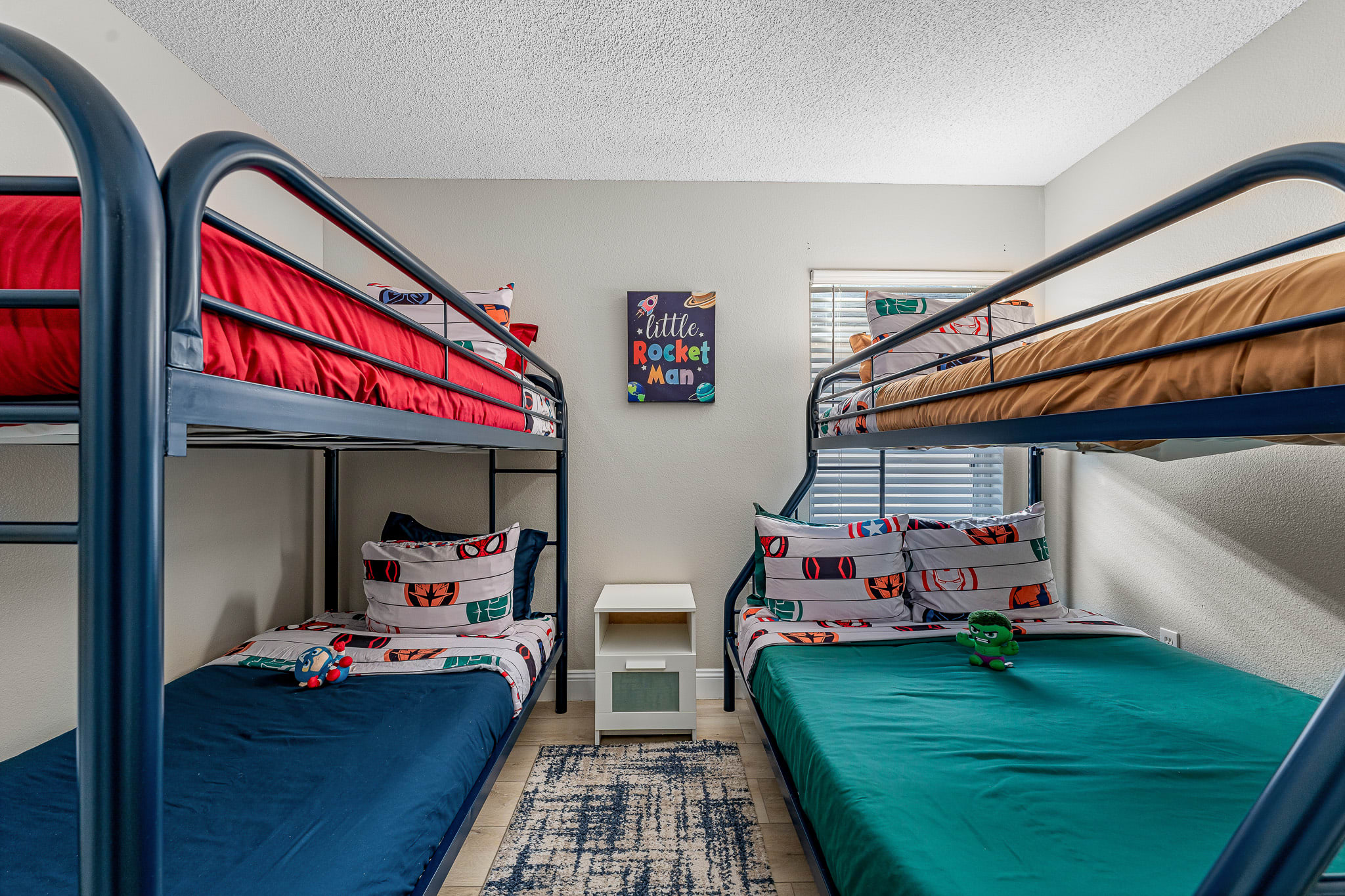 Spacious bunk room w/ multiple beds and a lively, playful atmosphere.