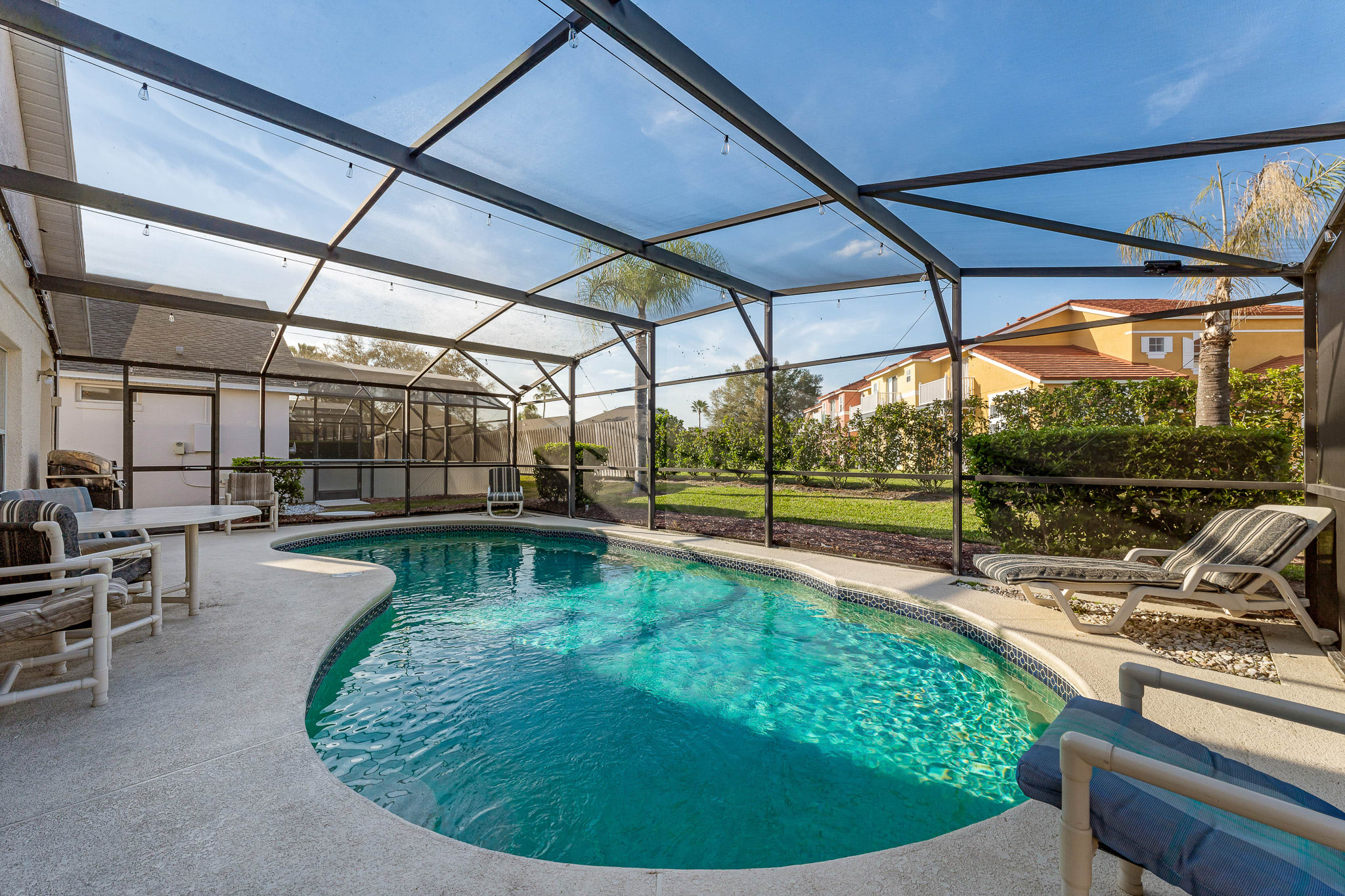 Screened pool enclosure w/ clear views and plenty of space to unwind.