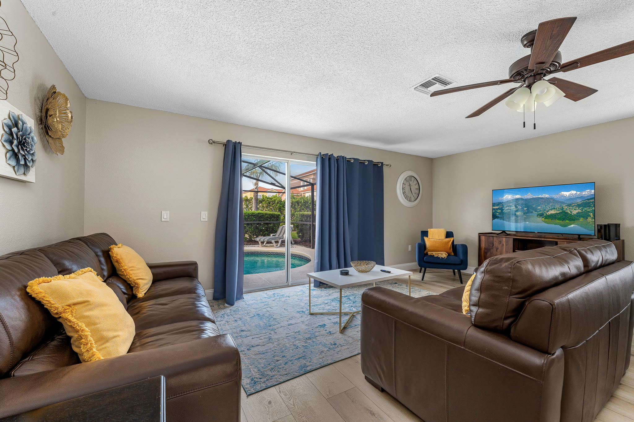 Inviting lounge space w/ plush seating, TV, and sliding doors to the outside.