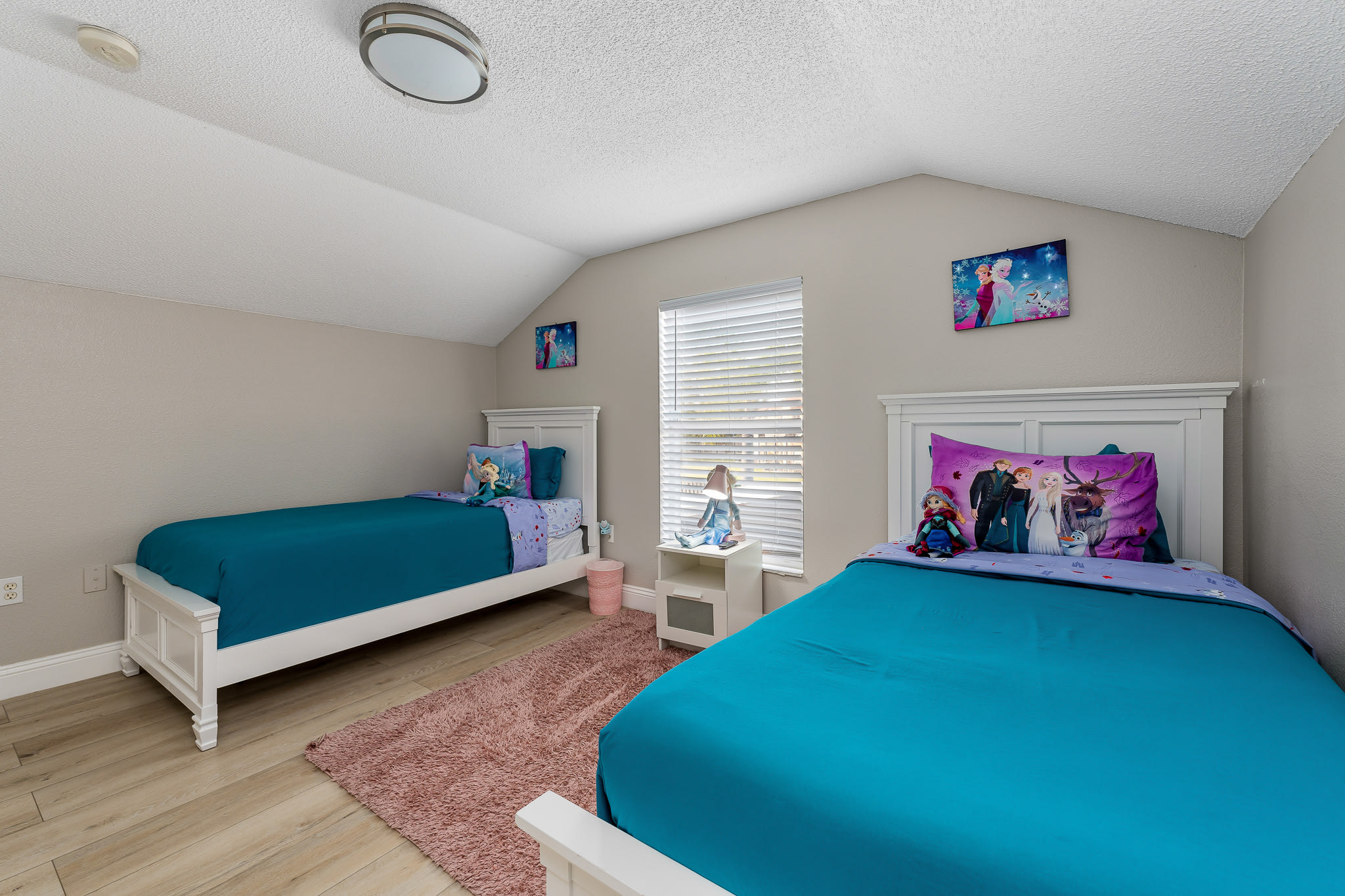 Cheerful bedroom w/ colorful bedding and a cozy, welcoming feel.