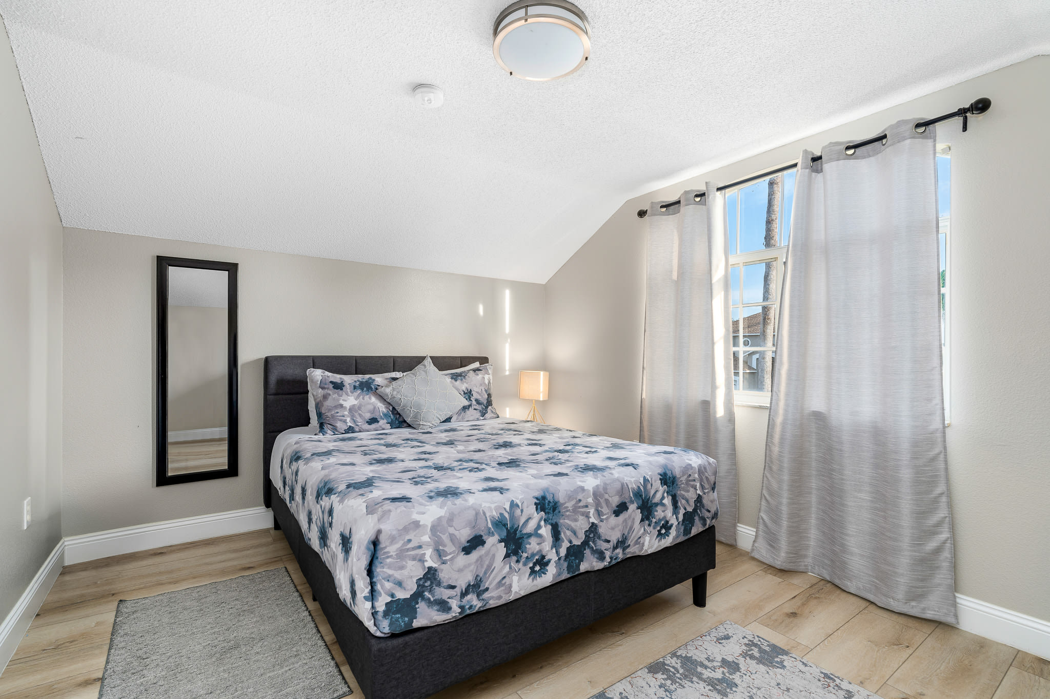 Comfortable bedroom w/ patterned bedding and a laid-back, welcoming vibe.
