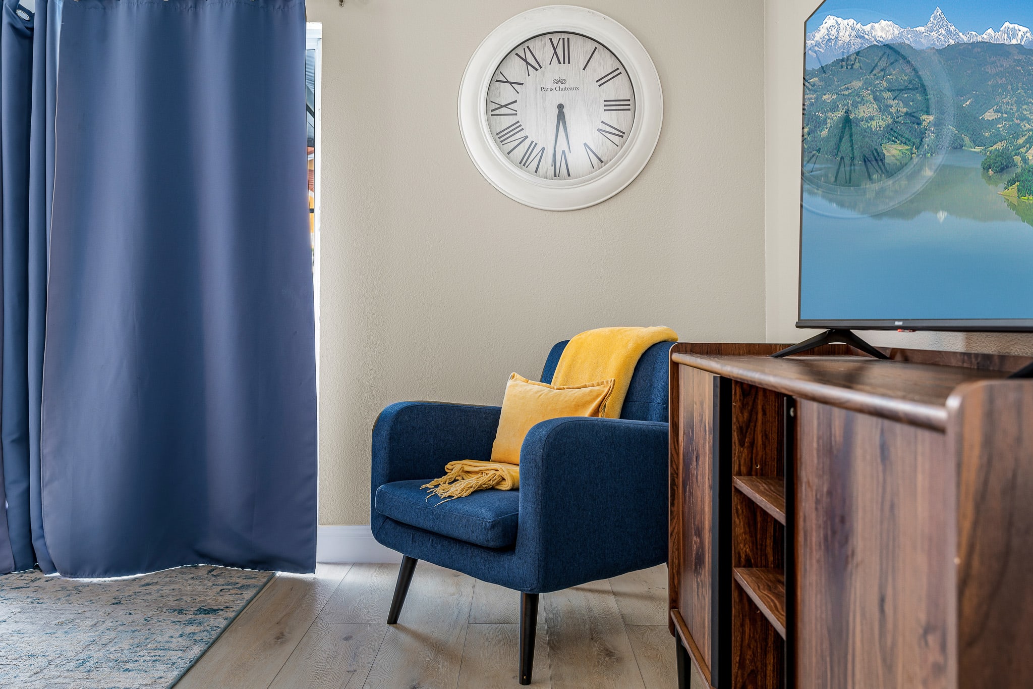 Relaxing sitting nook w/ armchair, side table, and calm coastal vibes.