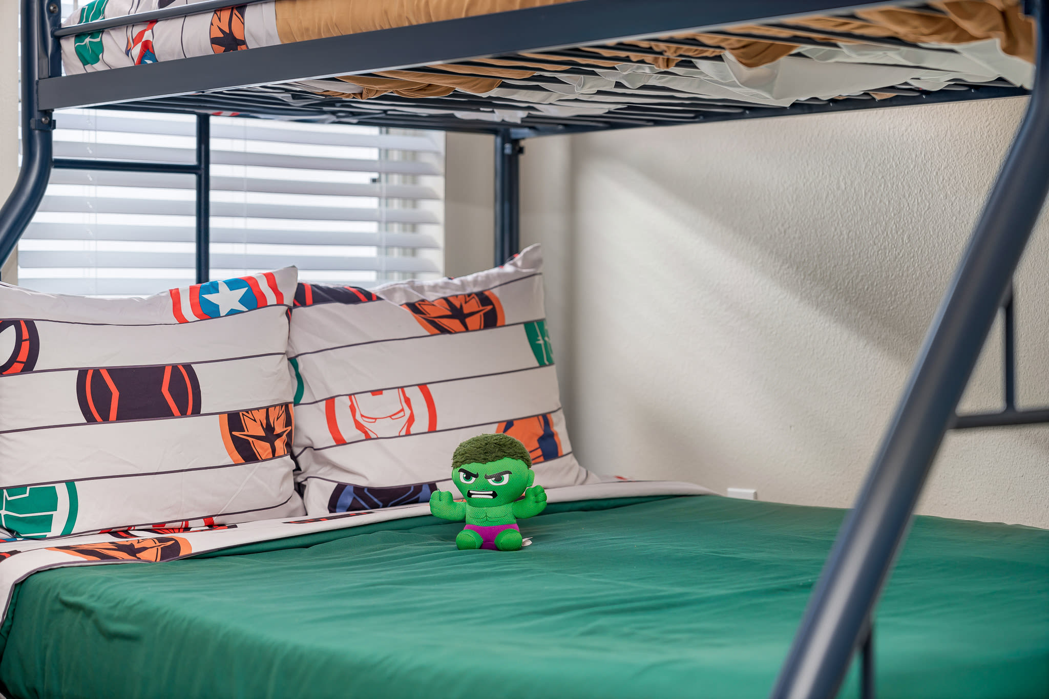 Kid-friendly bedroom w/ bunk beds and an open area for play.