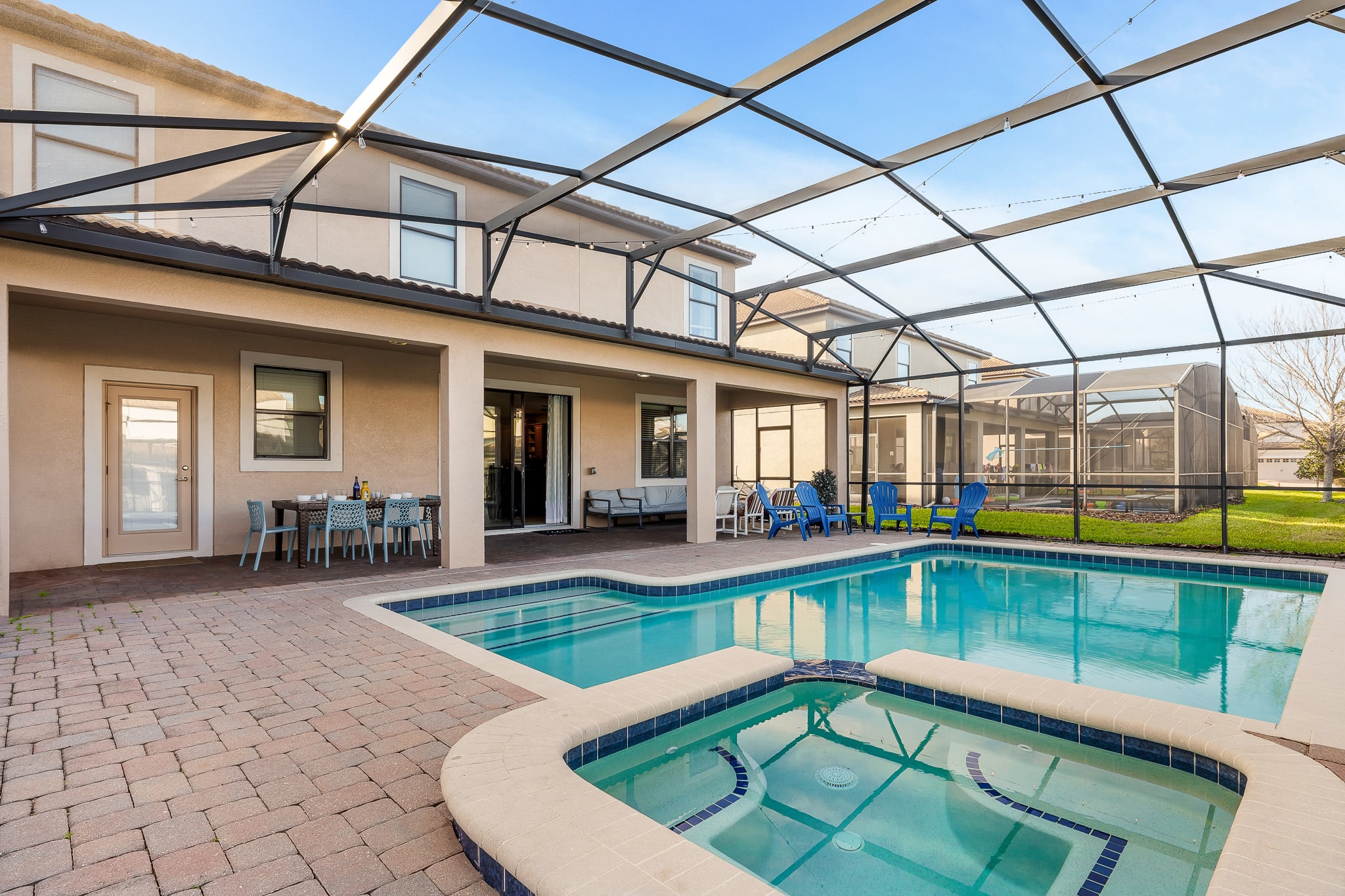 Screened-in pool & spa area ideal for laid-back swims and easy indoor-outdoor lounging.