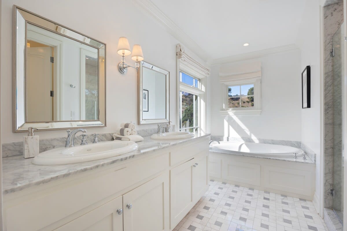 Custom marble and tiles features and stunning his and hers sinks