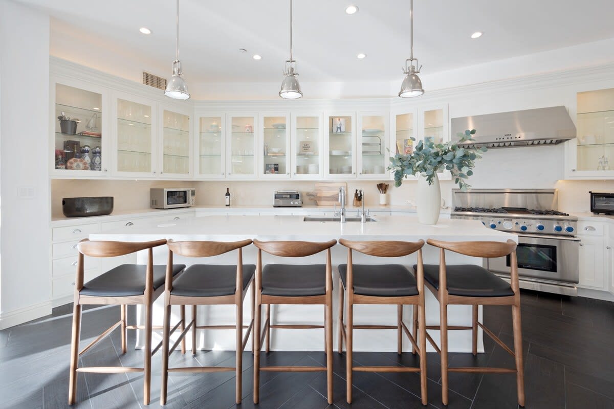 Additional seating area at the kitchen counter island with modern overhead lights