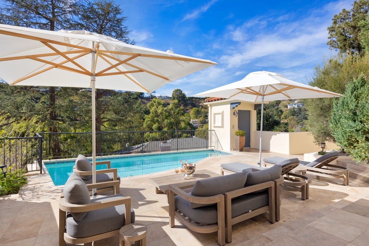 Enjoy a refreshing afternoon in the pool or relax on the sun loungers overlooking the green view