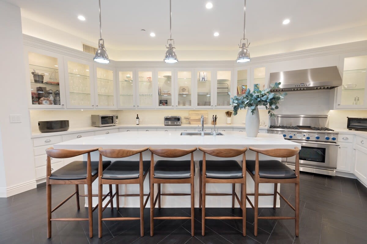Additional seating area at the kitchen counter island with modern overhead lights