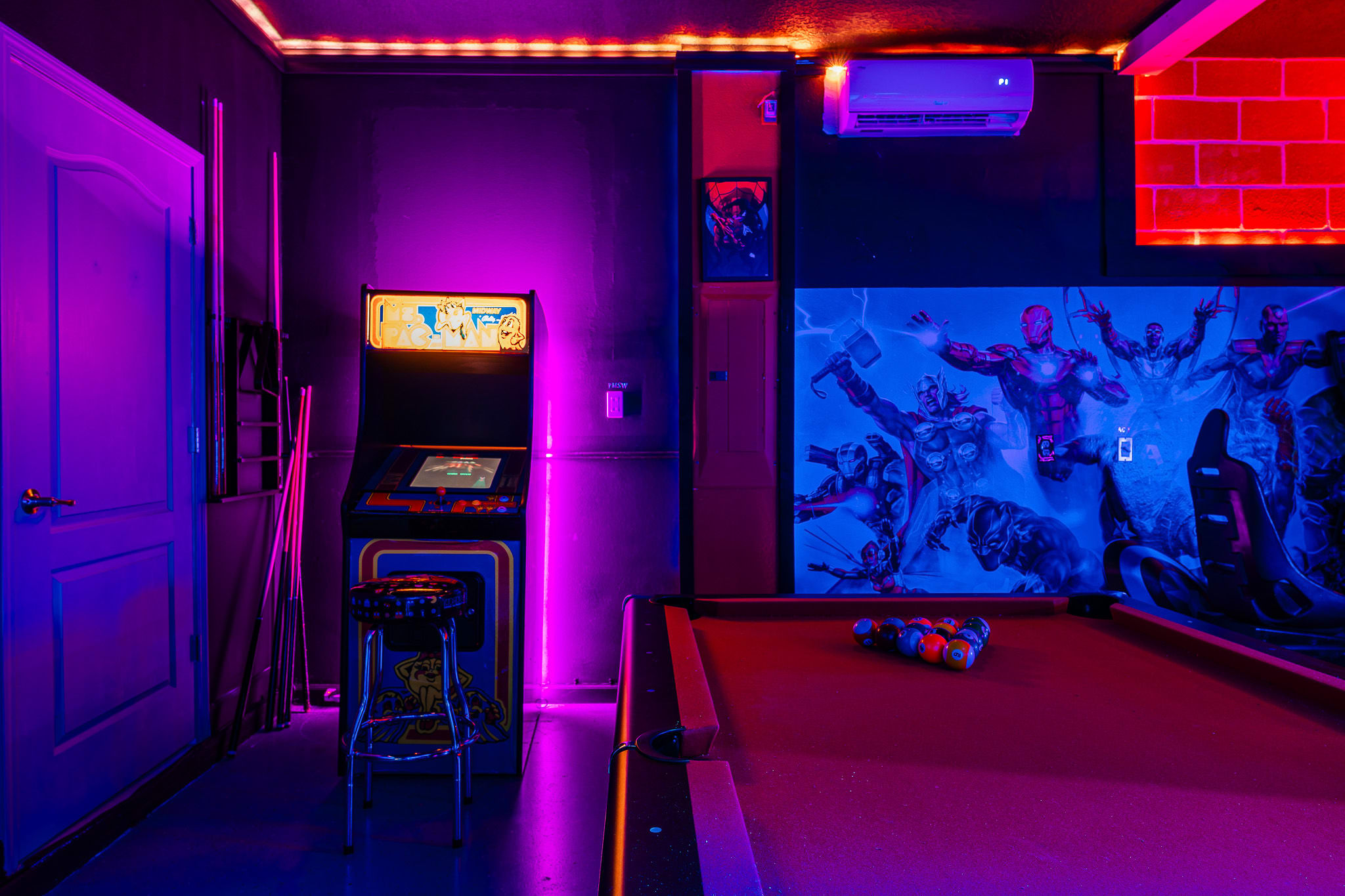 Vibrant arcade-style room w/ glowing lights and playful energy.