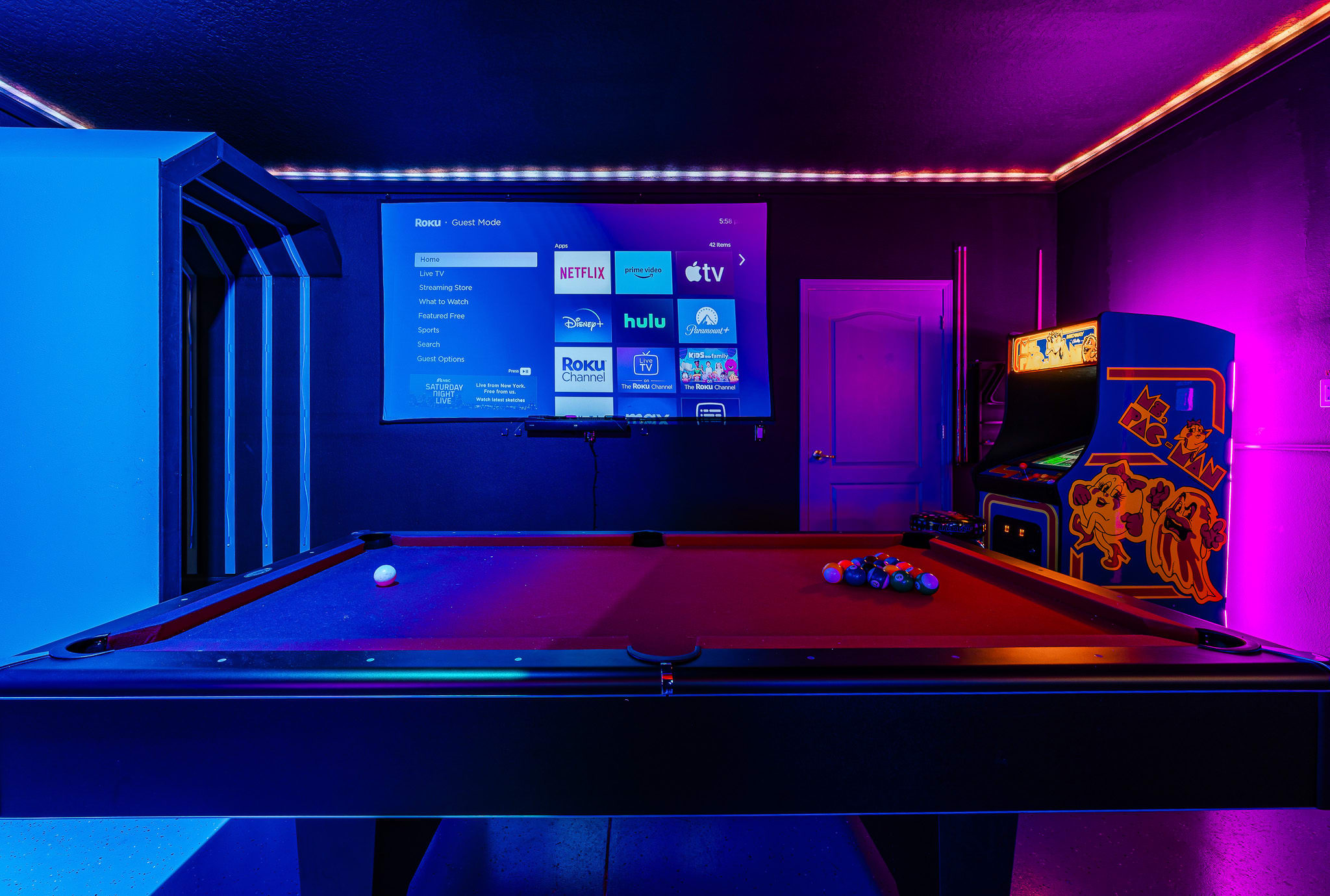 Futuristic media room w/ LED accents for immersive movie or gaming sessions.