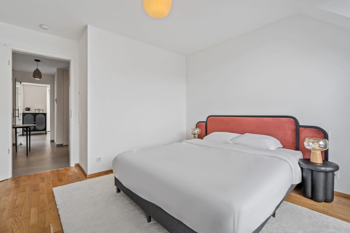 Chic bedroom with balcony access to enjoy your morning coffee with a view.