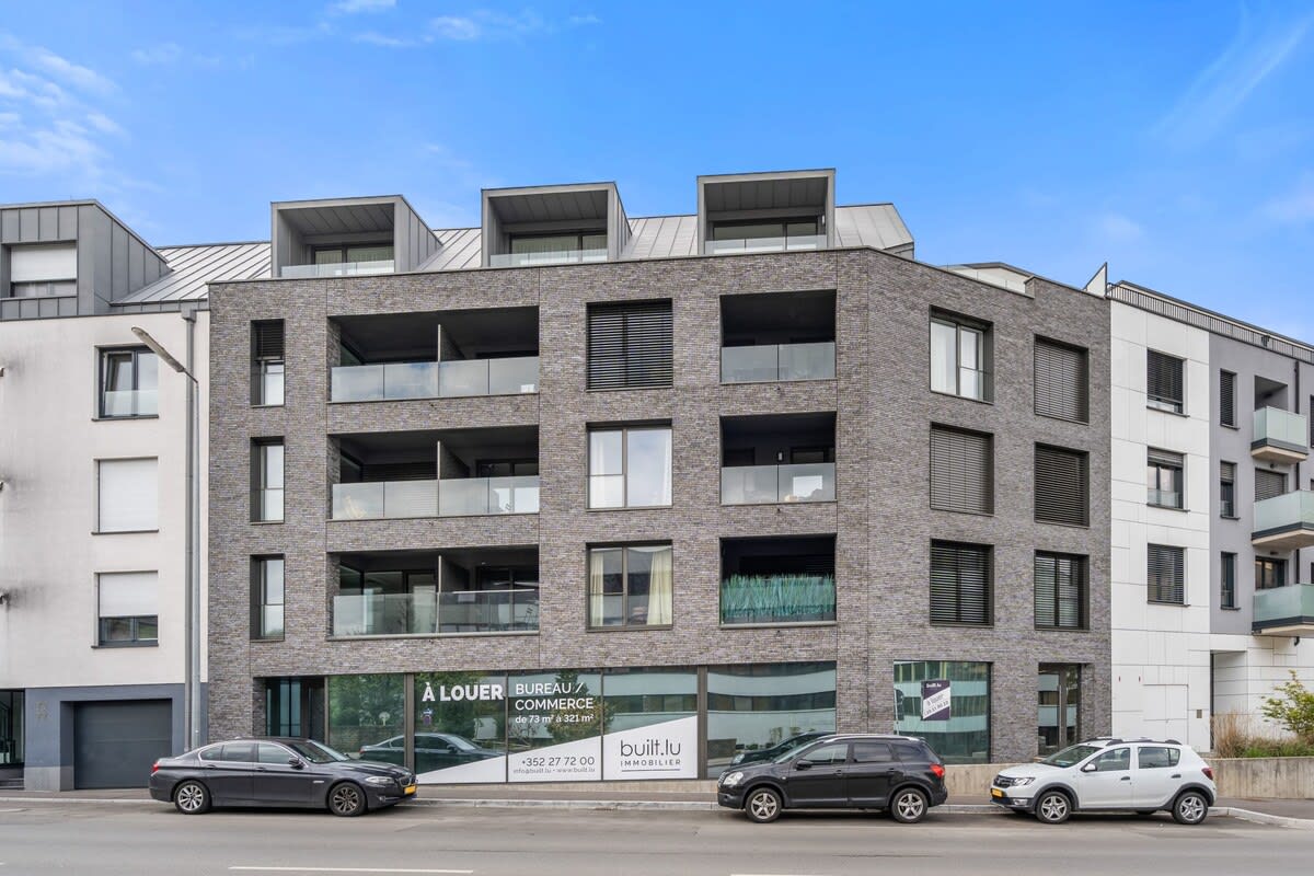 Modern apartment building with private balconies, conveniently located in the heart of the city, offering easy access to local amenities and attractions.