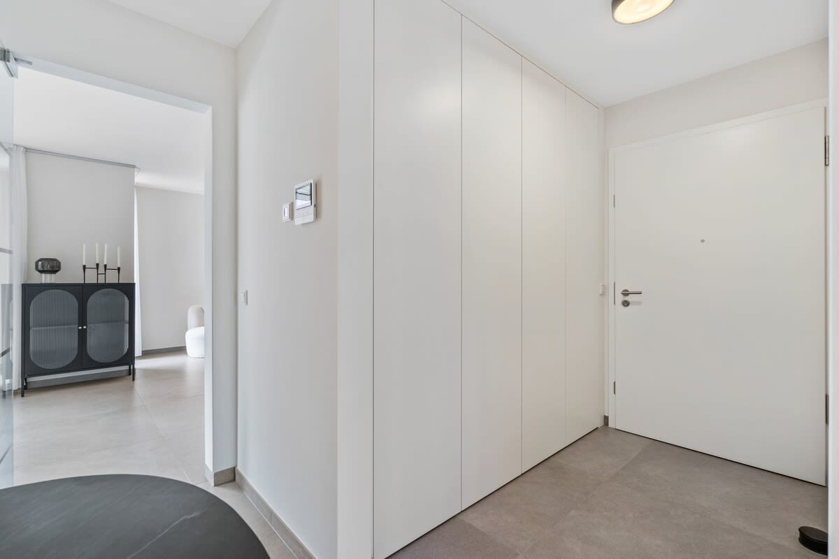 Bright and welcoming entrance hallway with ample storage space, setting the tone for a comfortable and organized stay.