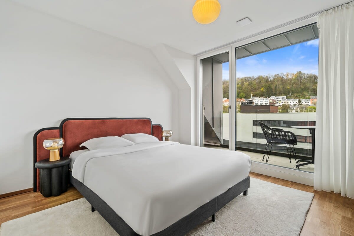 Rise with the sun in this inviting bedroom with direct terrace access.