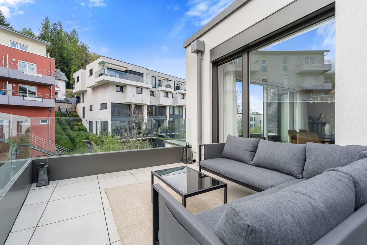 Unwind on the balcony, an urban oasis with stunning views and sleek seating.