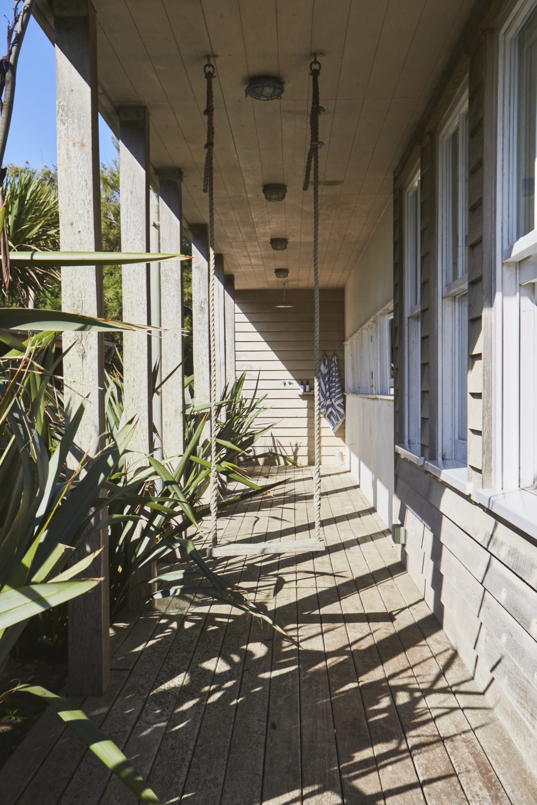 The outside of the home is beautifully decked, offering numerous places to sit, including a porch swing.