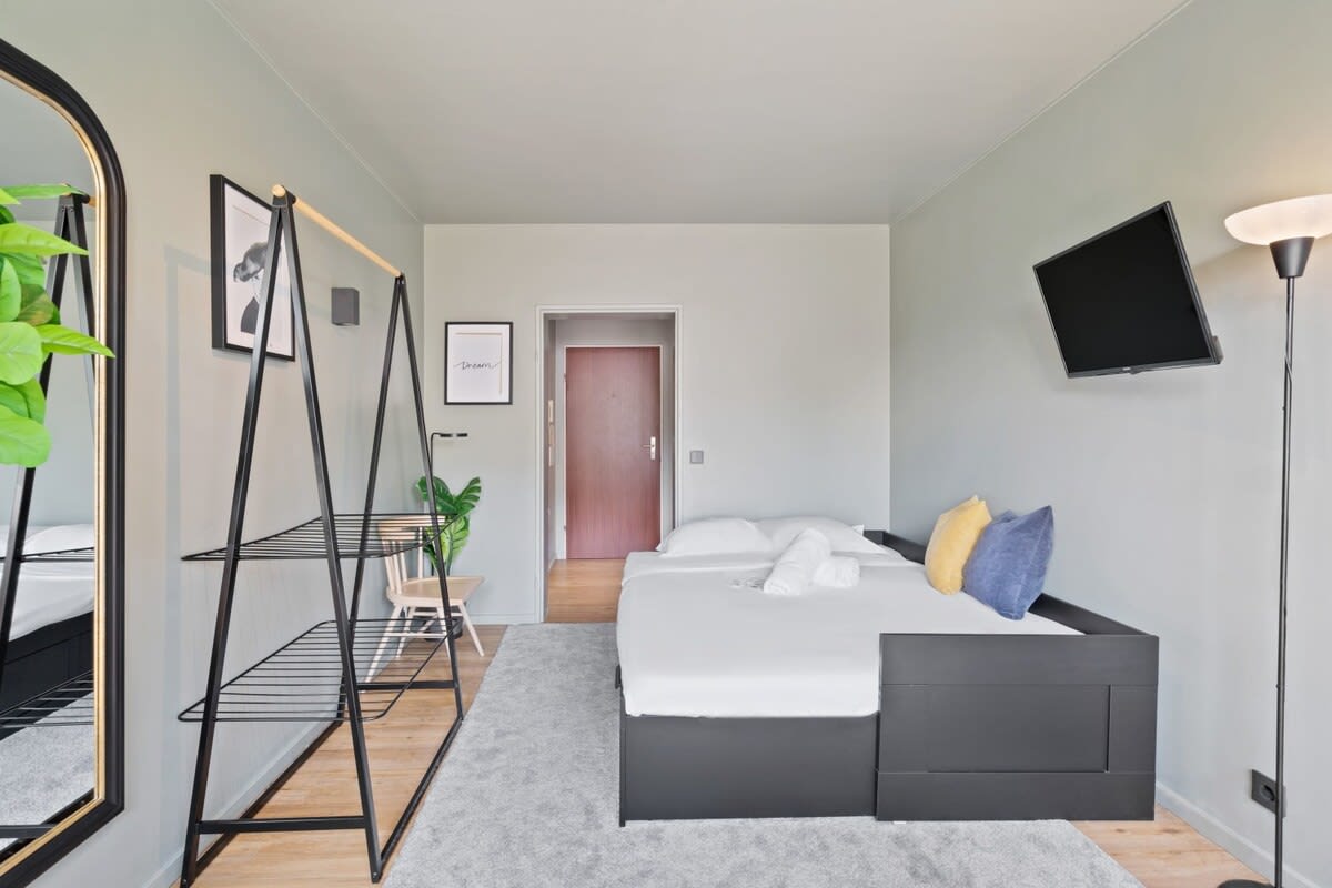 Unwind in style with this plush bedroom that promises sweet dreams.