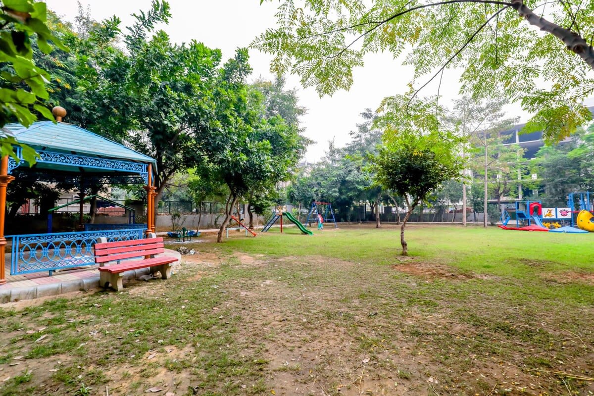 A picturesque view of the park, with lush greenery, walking paths, and a serene natural setting.