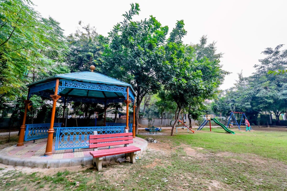 A picturesque view of the park, with lush greenery, walking paths, and a serene natural setting.