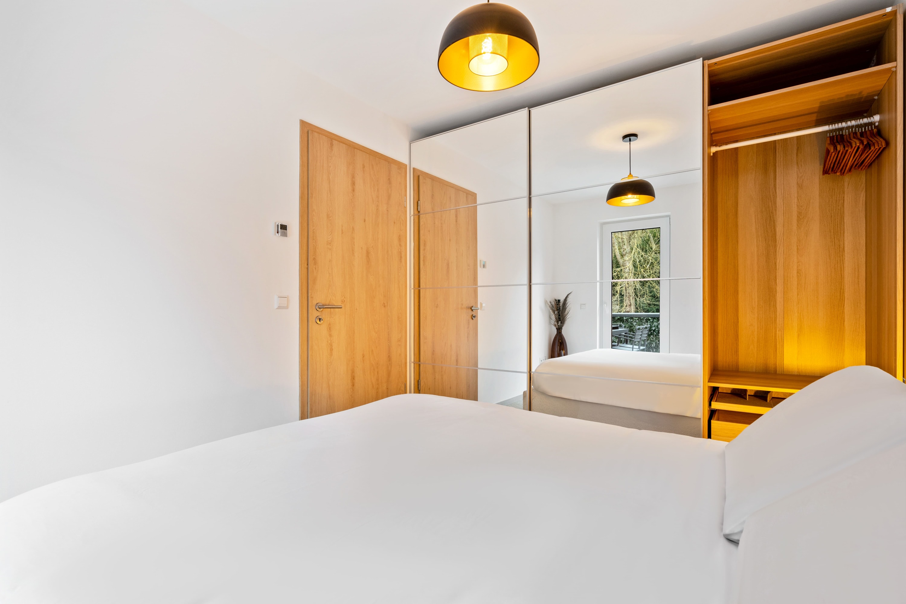 Tranquil bedroom space with natural light and elegant decor.