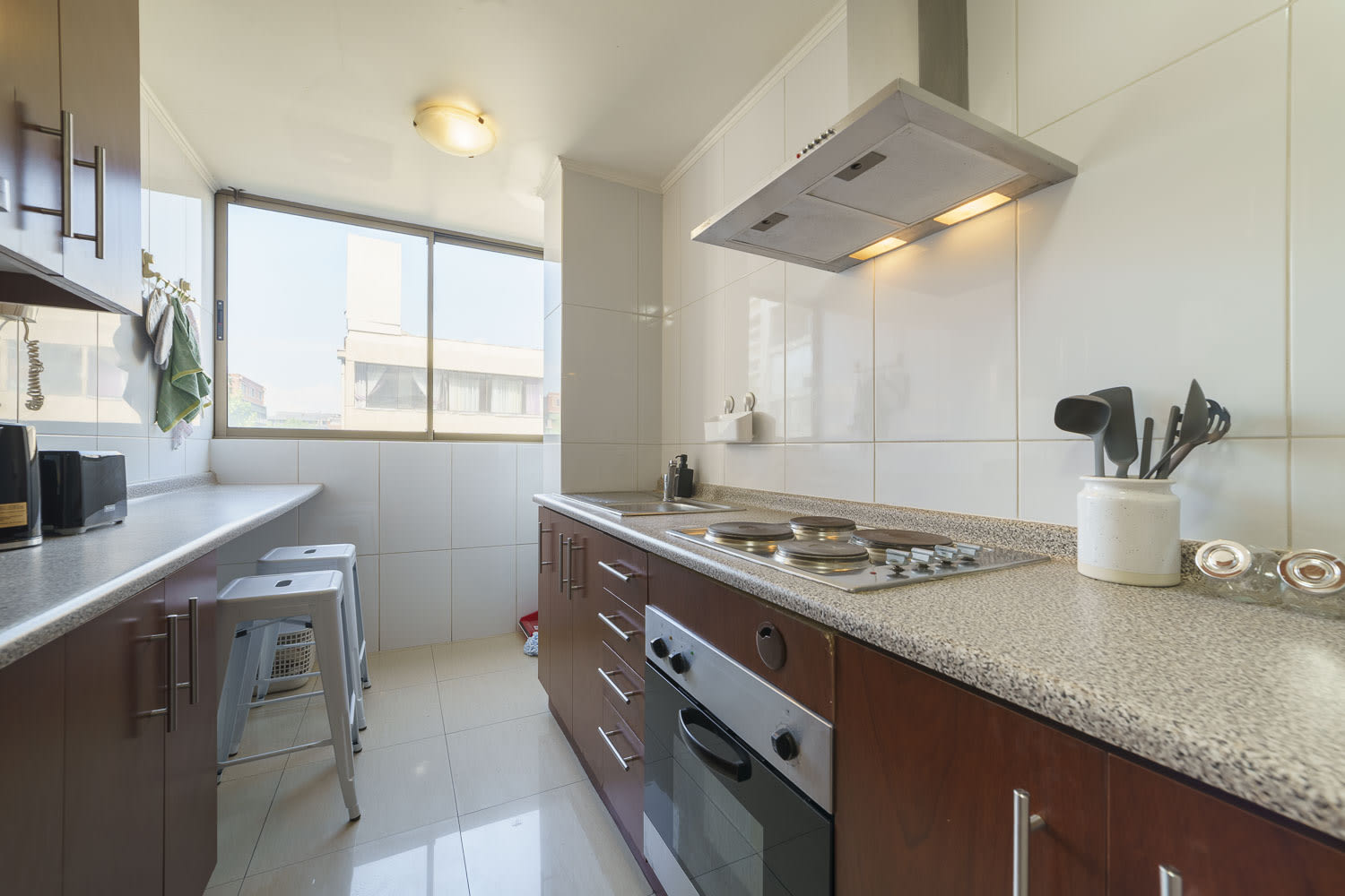 Bright and modern kitchen with ample counter space and natural light, perfect for culinary creations.