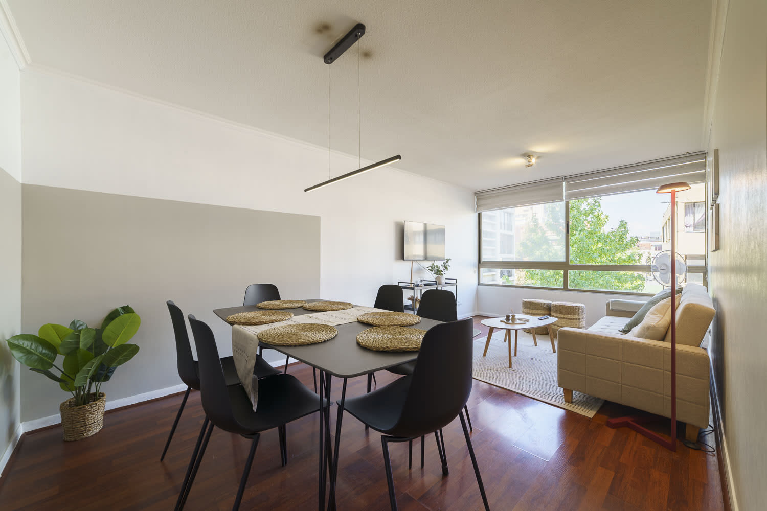 Spacious and bright living area with modern decor and ample seating, perfect for relaxation and dining.