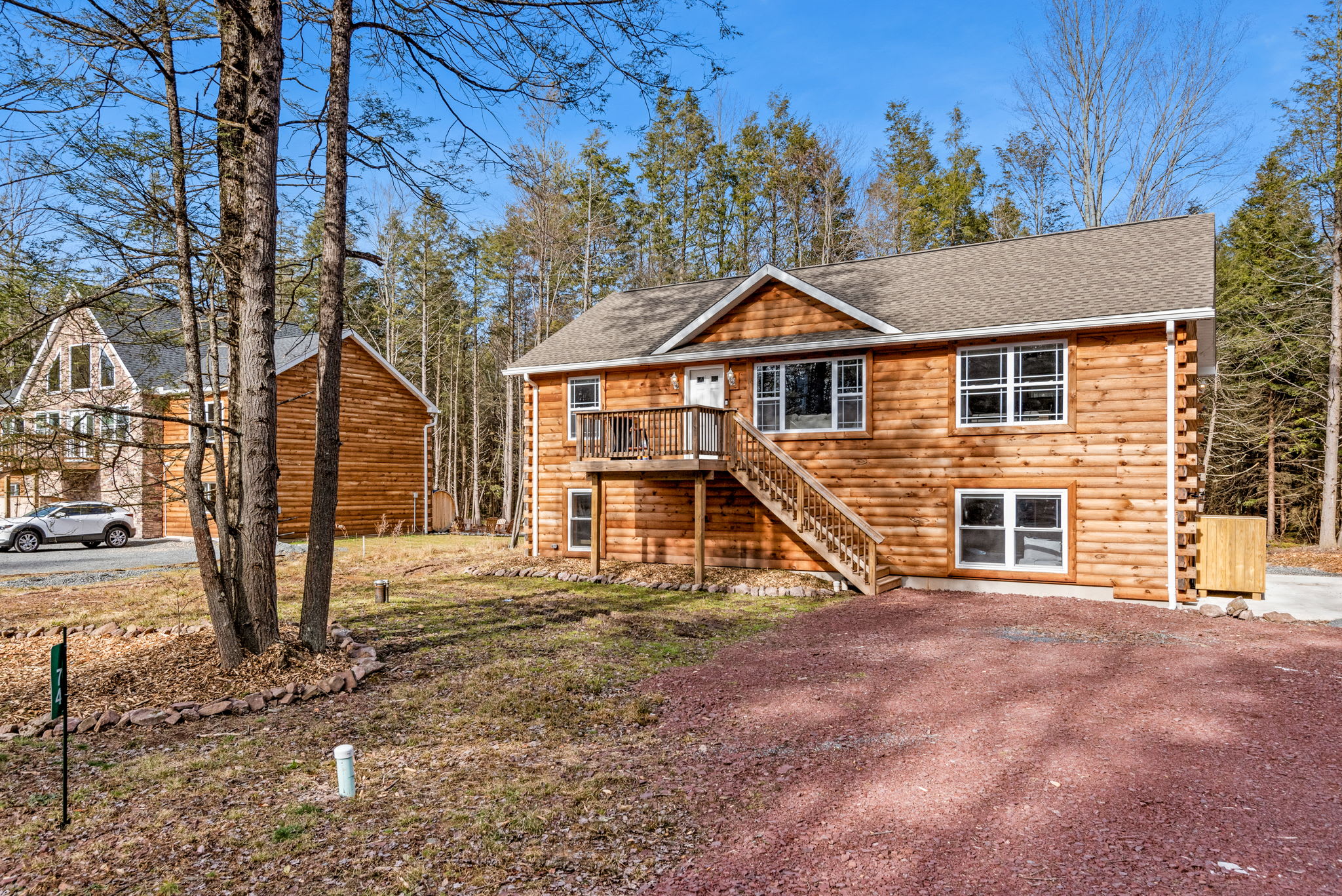 Woodland Drive-Up Appeal
With easy parking and tall pines all around, this peaceful home feels like a true retreat the moment you arrive.
