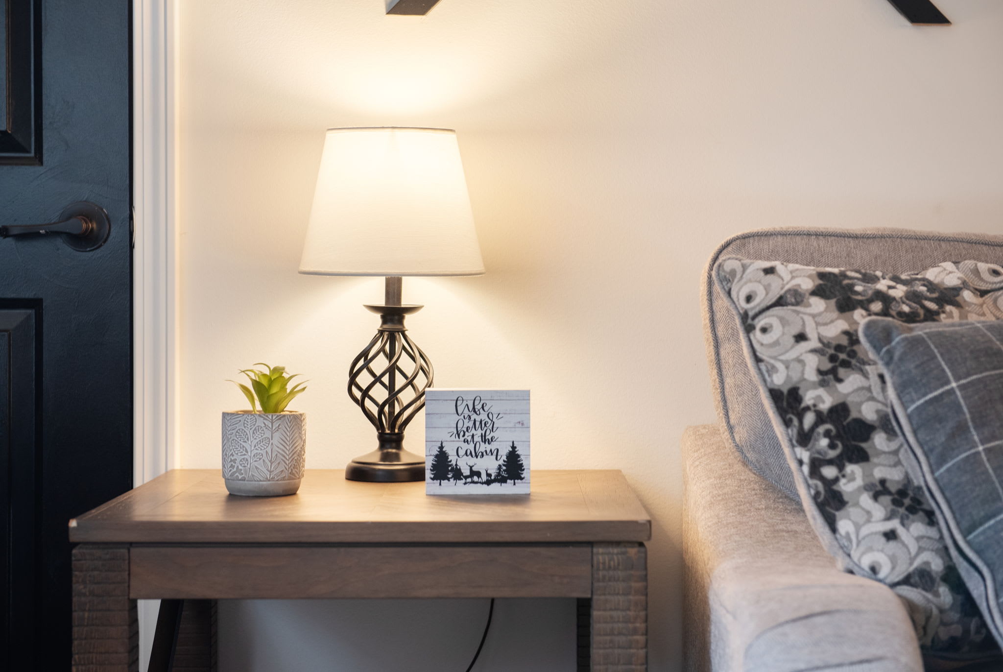A cozy corner featuring soft lighting, textured pillows, and just the right ambiance for curling up with a book or a warm drink.