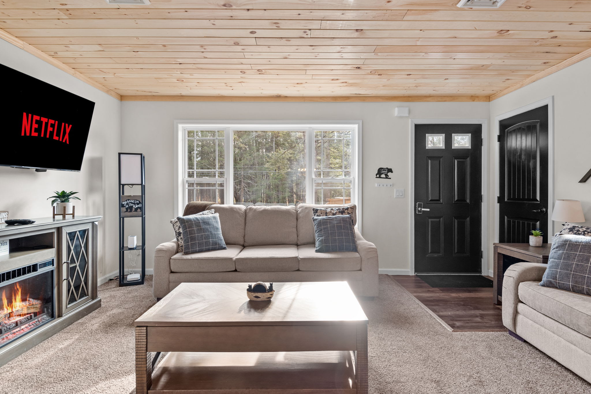 With natural light streaming in, plush seating, and a fireplace + TV setup, this living area is made for comfort, connection, and laid-back lounging.