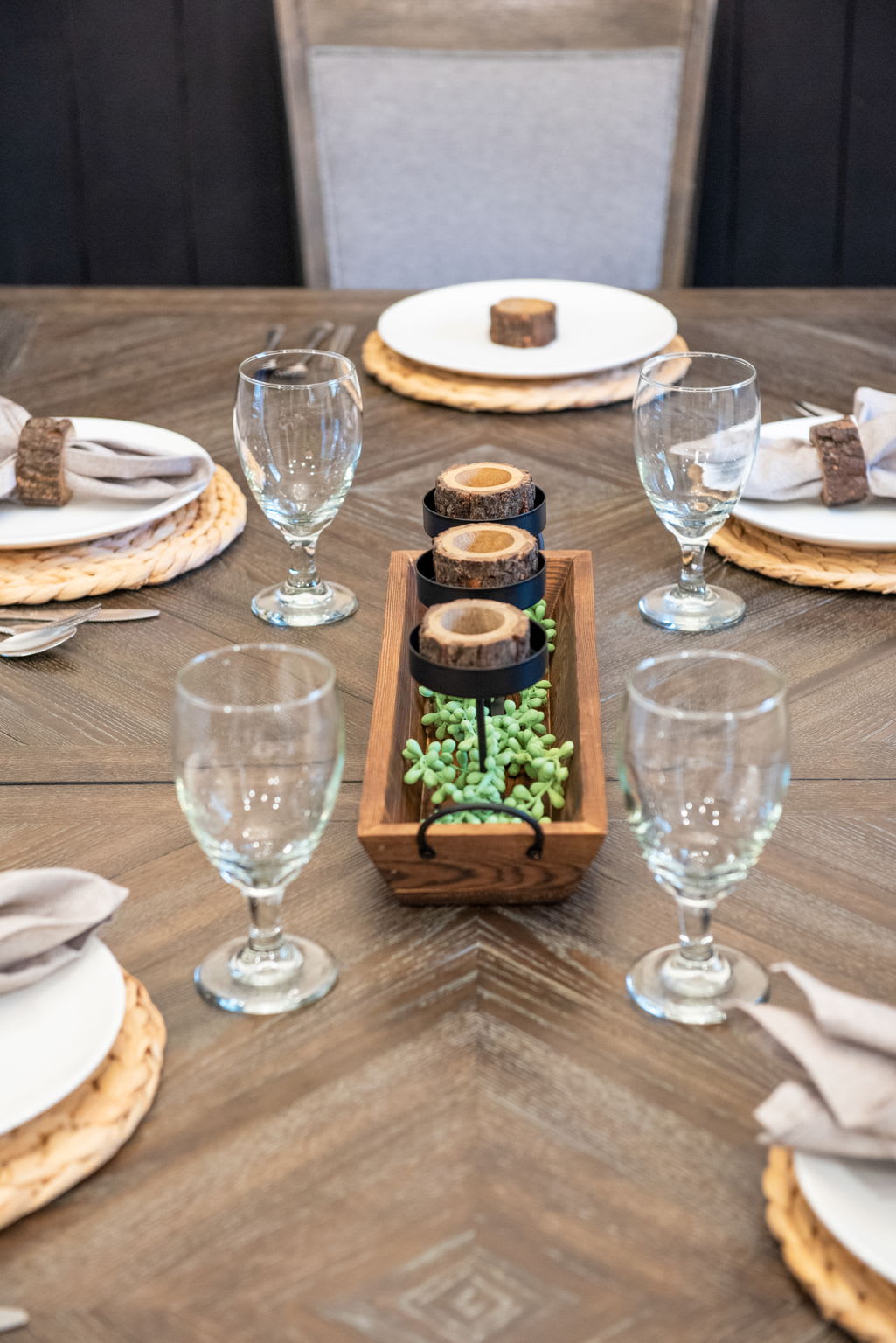 The table’s natural wood grain and earthy place settings add a rustic yet refined feel, inviting everyone to gather and stay a while.