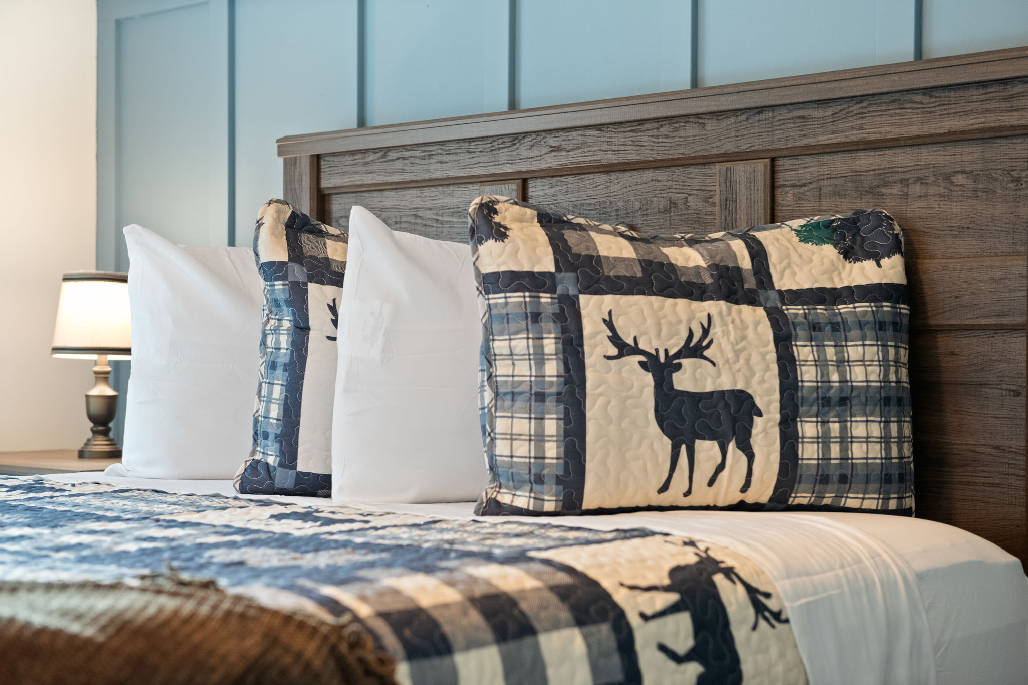 With charming moose and bear patterns on the bedding and a wood-paneled feature wall, this room feels like a high-end cabin suite.