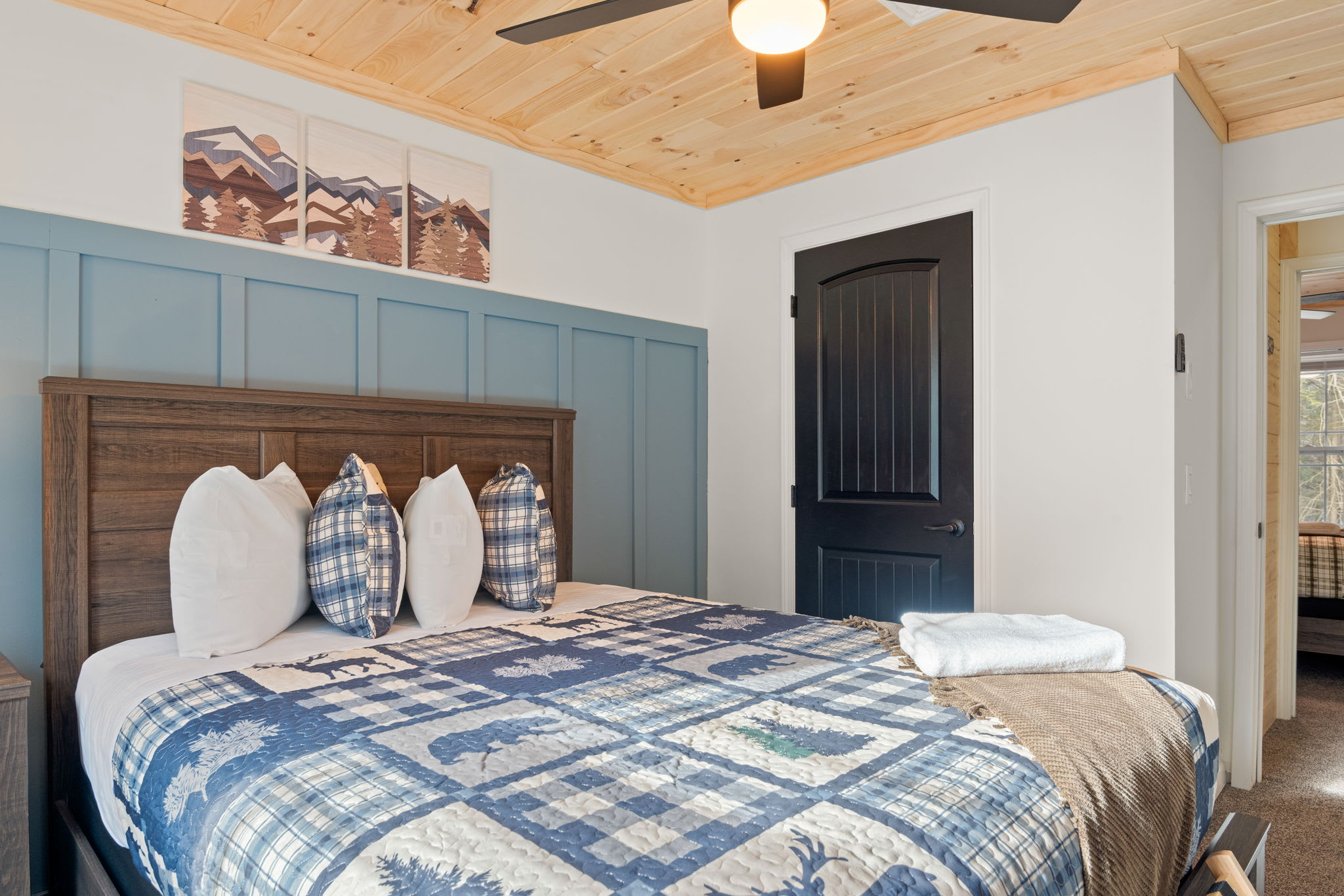 Cozy & Character-Filled Sleep Space
The mix of cool tones, playful cabin patterns, and wood ceilings creates a serene and stylish atmosphere perfect for winding down.