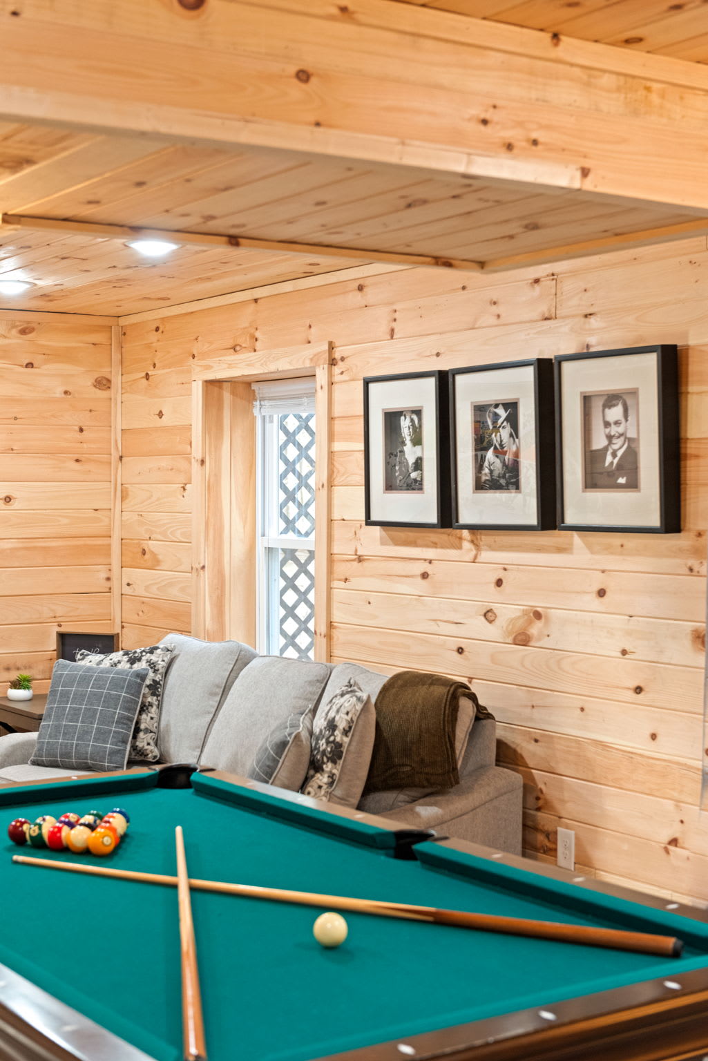 With natural wood walls and framed art accents, this corner of the game room invites both style and comfort while you rack 'em up.