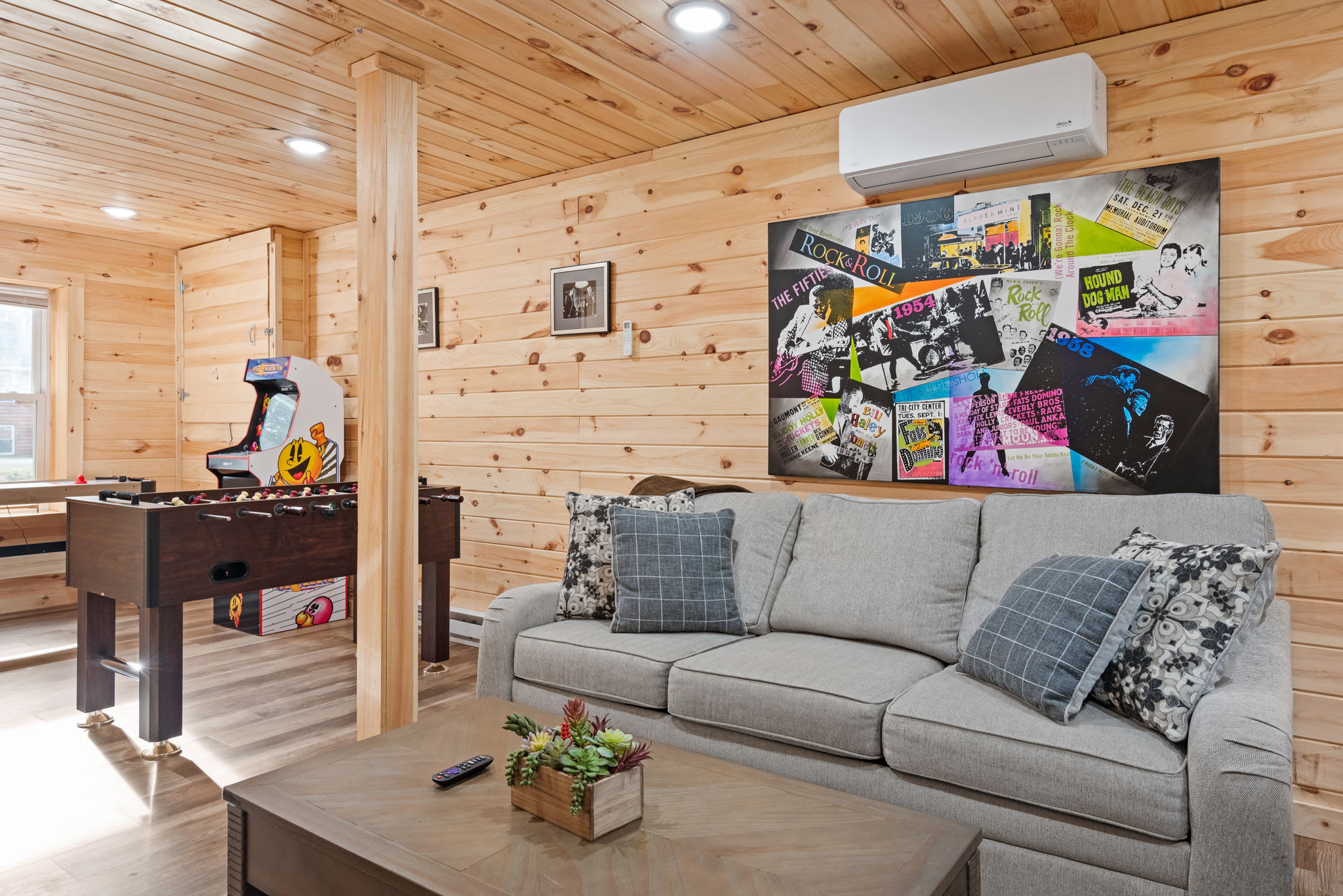 Chill, Chat, & Challenge Each Other
From comfy seating to nostalgic wall art and good lighting, this space brings together cabin charm and game night energy in one awesome hangout.