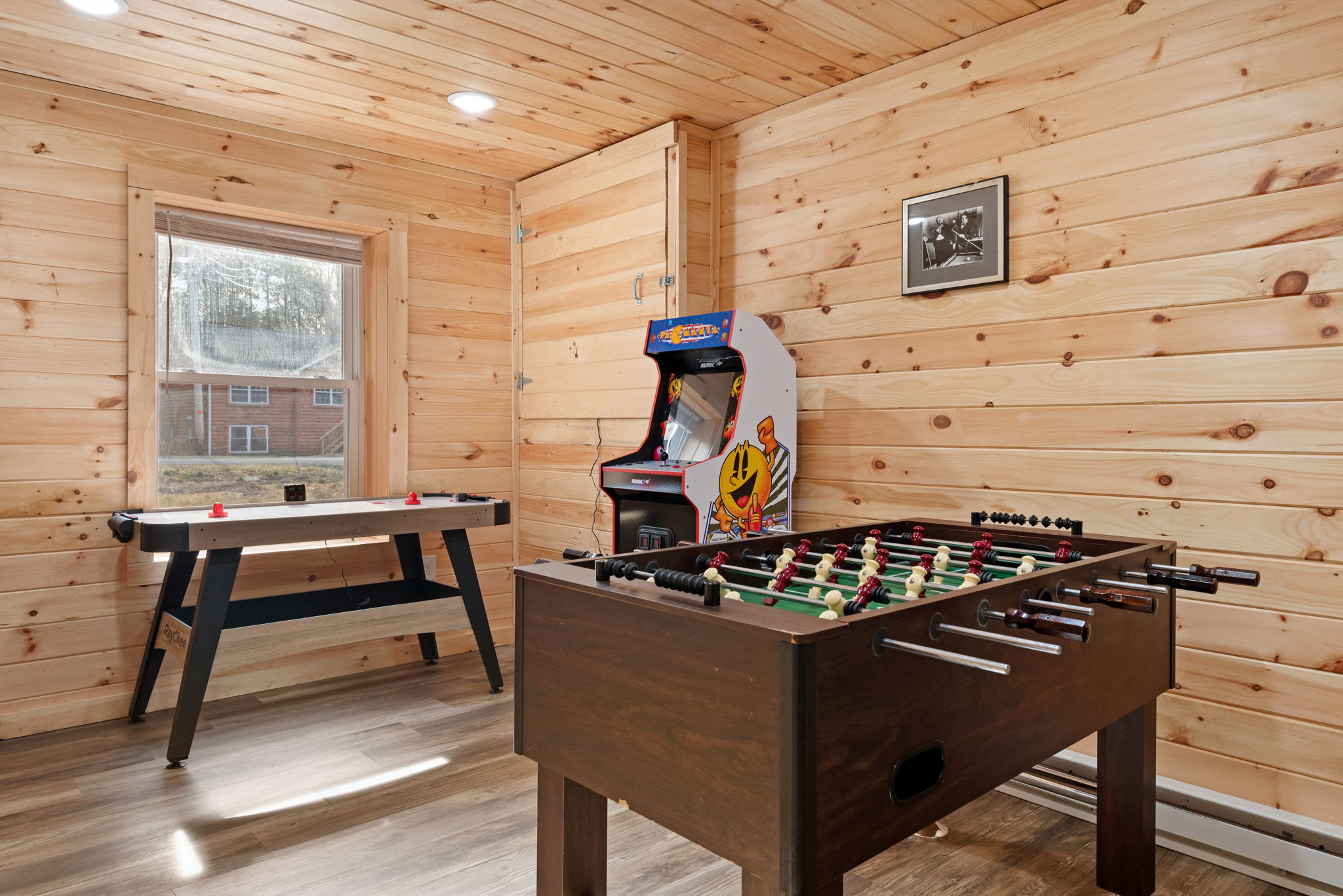 Foosball, air hockey, and retro arcade fun all set in a warm, wood-paneled game nook that feels straight out of a mountain lodge.