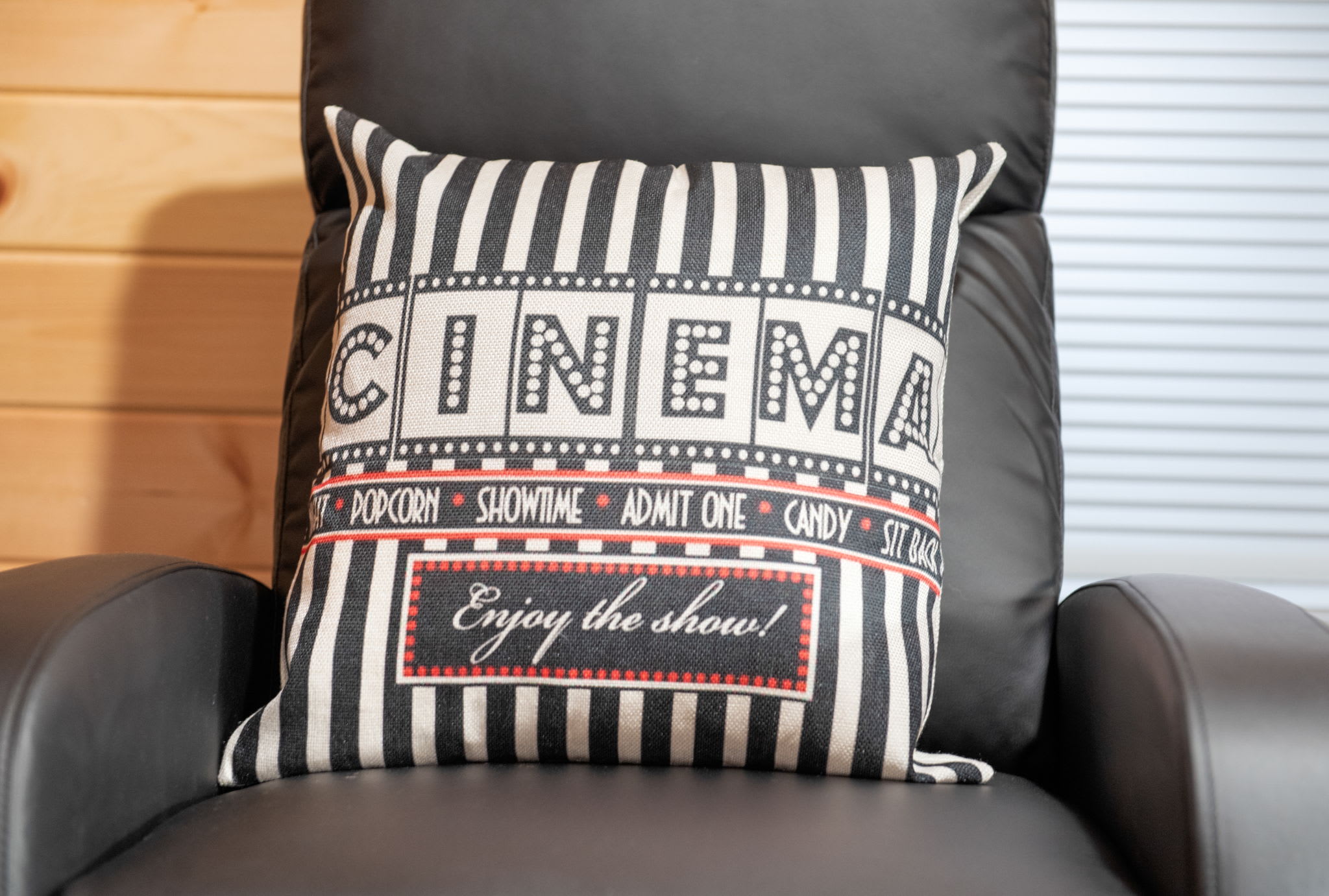 Cinema Vibes Built In
Thoughtful touches like this movie-themed pillow and plush leather chair bring a fun, immersive experience that any film lover will adore.