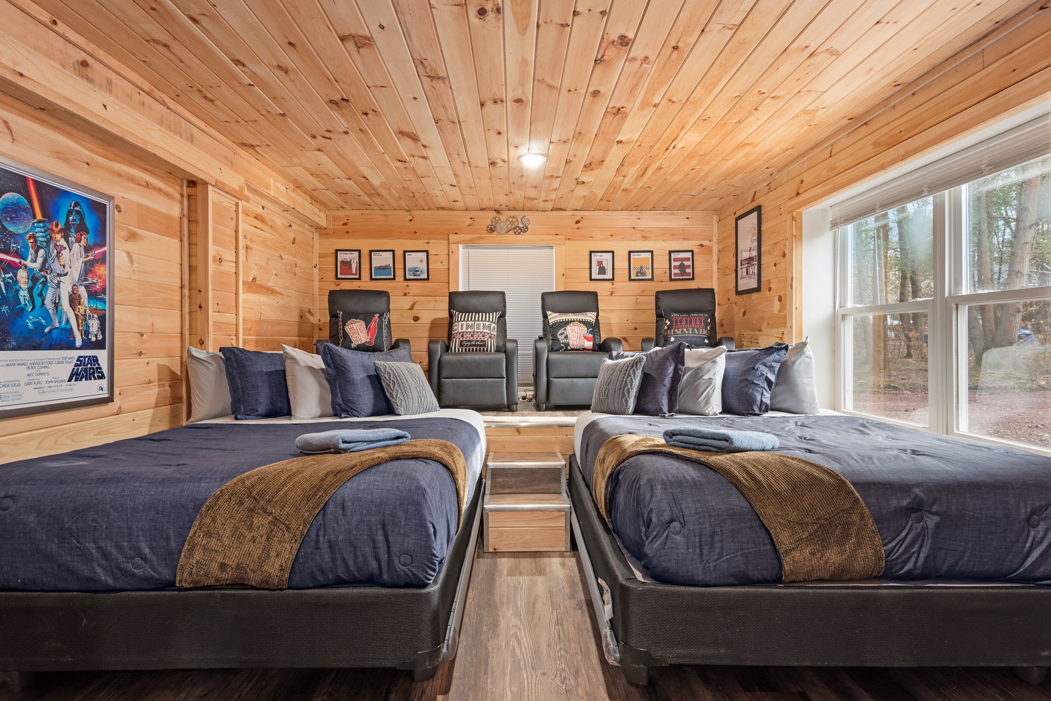 Movie Room Bedroom – Sleep & Screen in Style
This unique bedroom doubles as a cozy theater, complete with reclining beds, cinema-style pillows, and a big-screen TV for movie marathons.