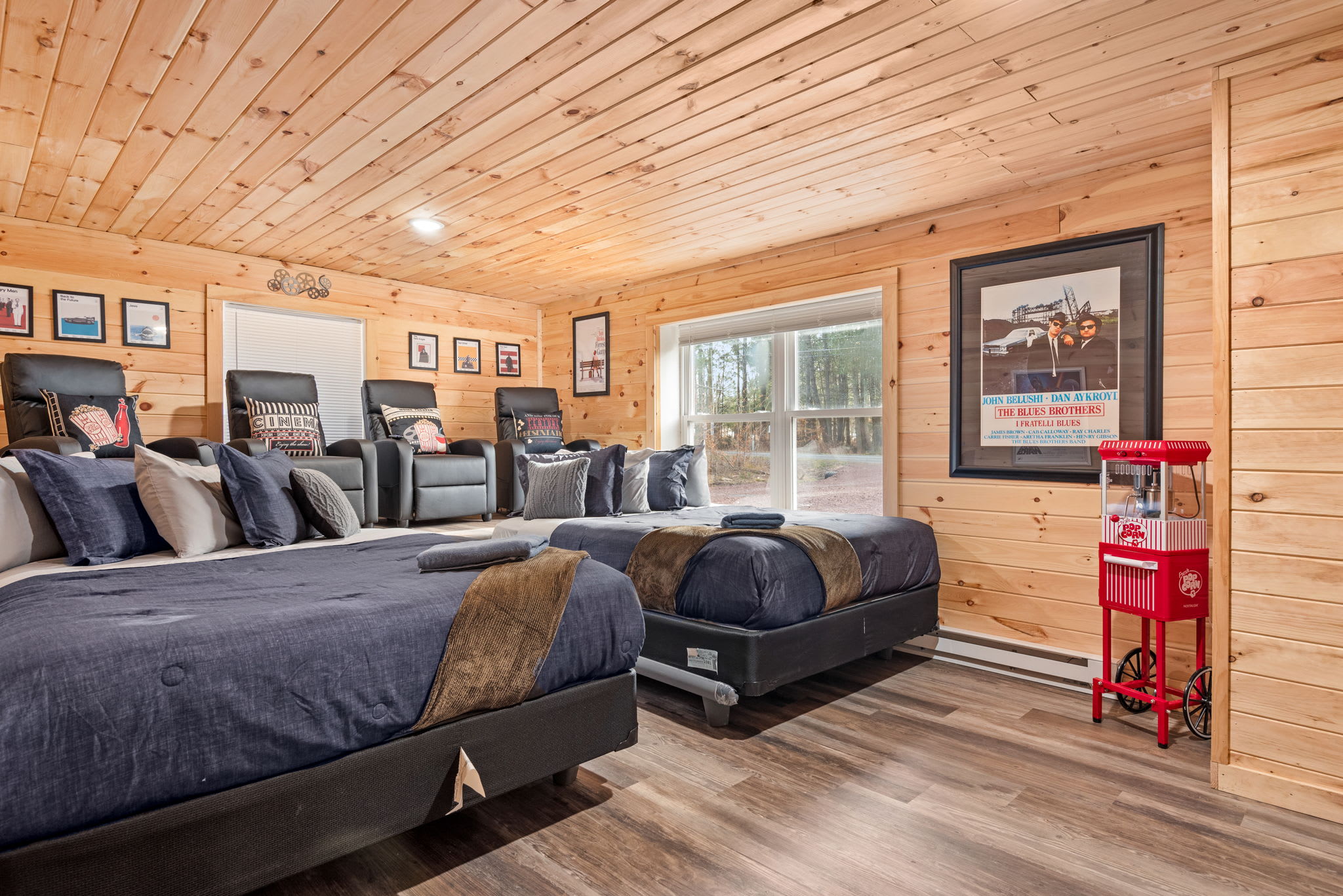 Ultimate Theater-Style Bedroom
Kick back in plush reclining beds and enjoy your favorite movies in this one-of-a-kind cinema-style room complete with cozy blankets, framed posters, and even a popcorn machine.