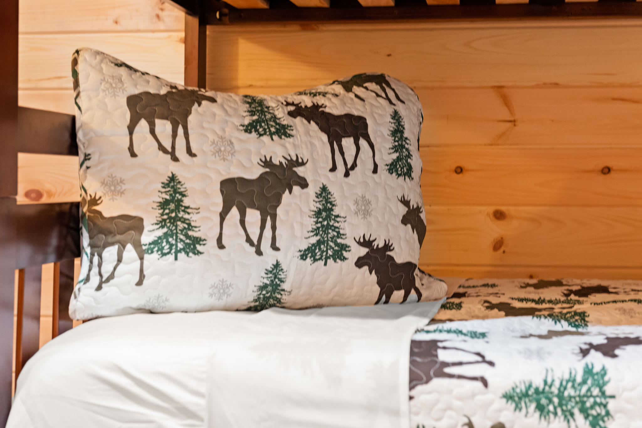 Moose, trees, and soft forest prints make this space feel like a little lodge all their own cozy, themed, and filled with personality.