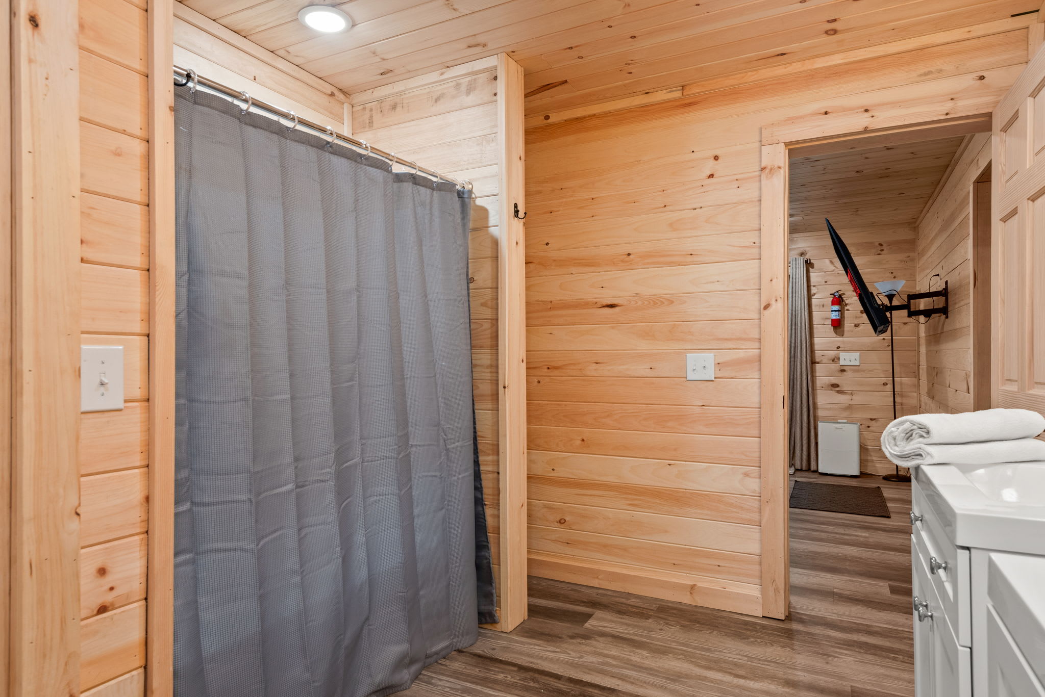 Tucked-Away Cabin Shower Nook
Simple, clean, and rustic this shower space offers a cozy corner to rinse off after a day of outdoor adventure, with soft wood tones keeping that cabin vibe strong.