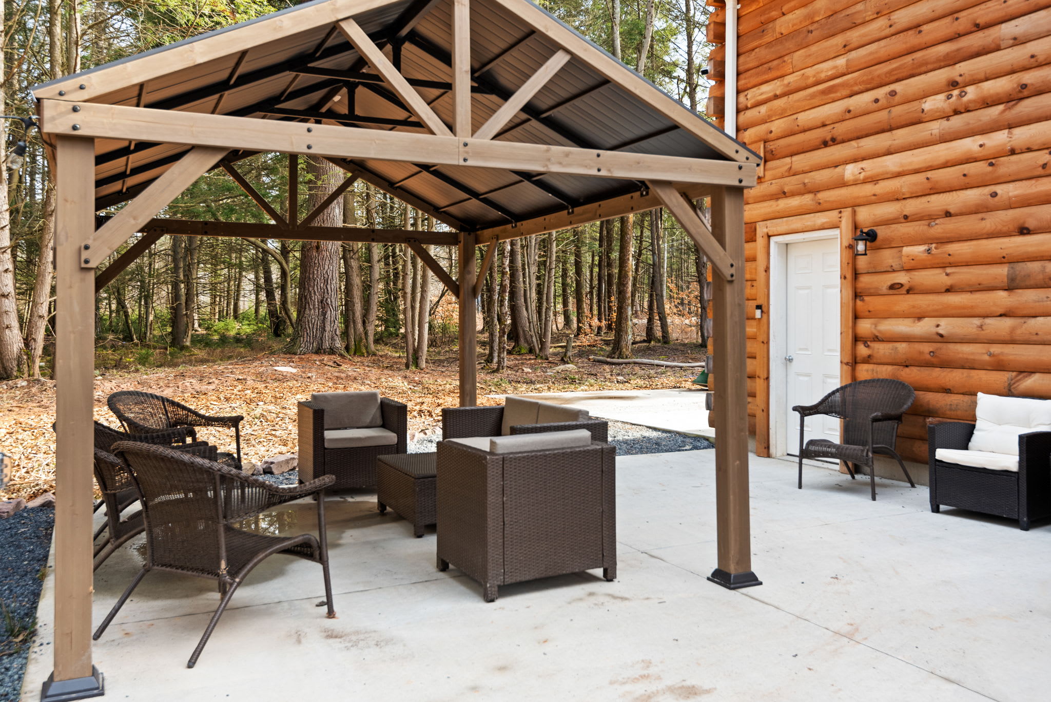 A shaded spot to sit back and connect perfect for outdoor meals, games, or simply soaking in the log cabin charm.