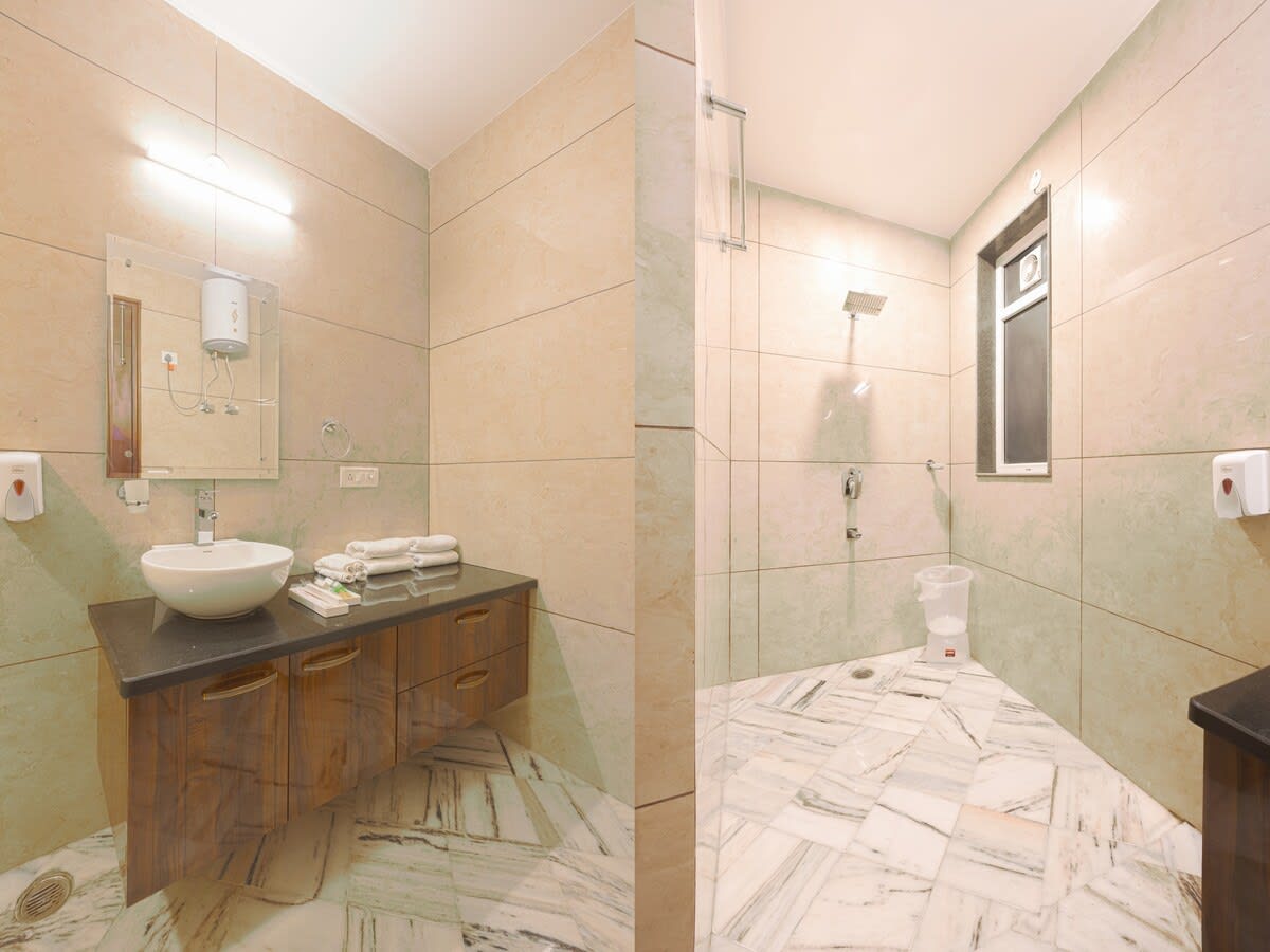 A private attached bathroom featuring modern fixtures, a shower, sink, and toilet for convenience and comfort.