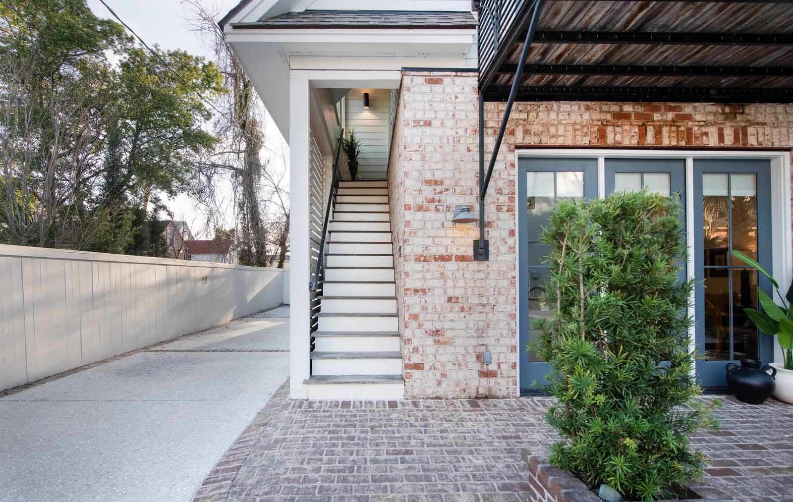 Walk up the exterior staircase to the upstairs loft of the back house!